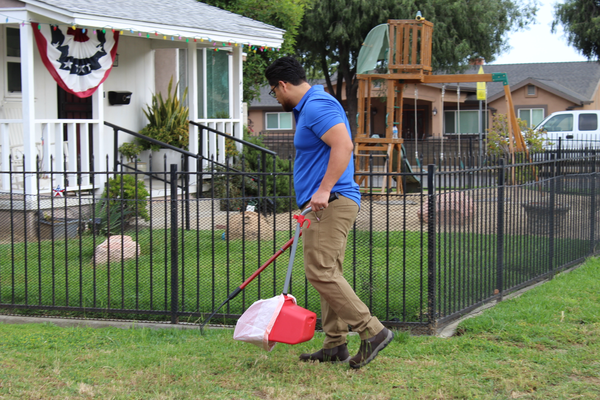 The Doggo Scoop technician cleaning a backyard with a happy dog nearby